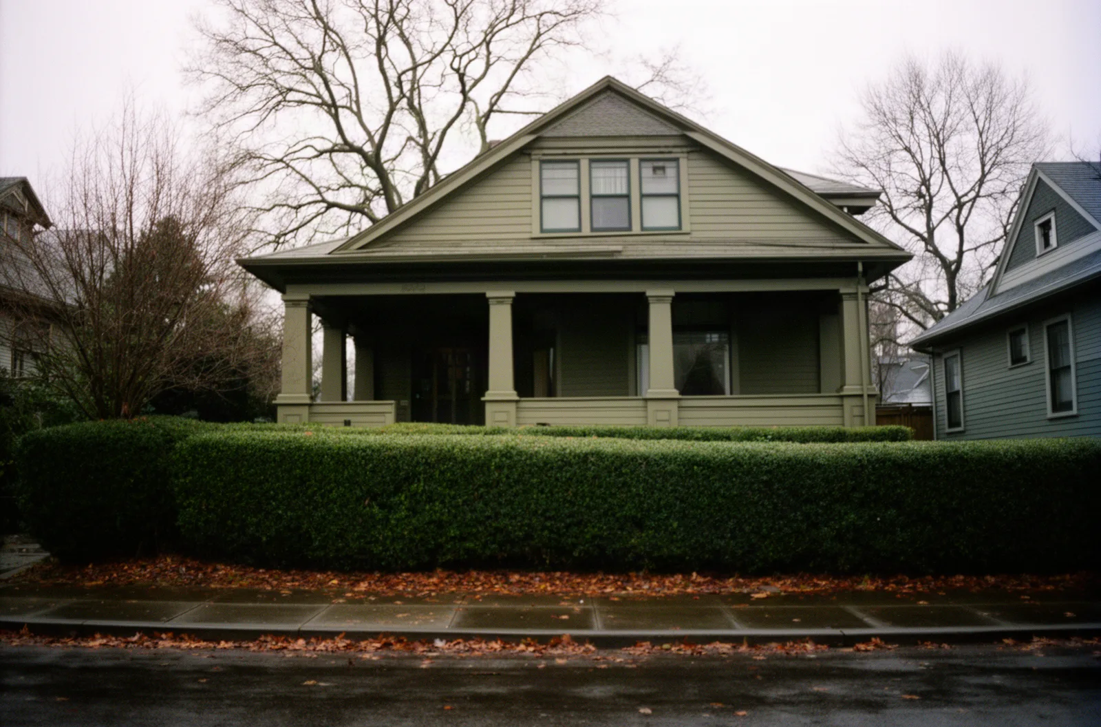 A foursquare house with a broad porch in a northeast Portland neighborhood